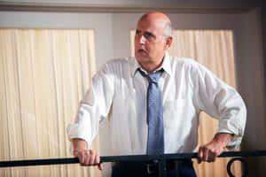 Renowned Actor Jeffrey Tambor Giving A Charismatic Smile In A Professional Shoot. Wallpaper