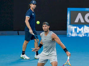 Respected Tennis Coach Carlos Moya Analyzing Nadal's Performance Wallpaper