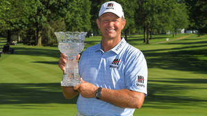 Retief Goosen Holding His Shimmering Crystal Trophy Wallpaper