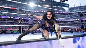 Rhea Ripley Celebratingin Wrestling Arena Wallpaper