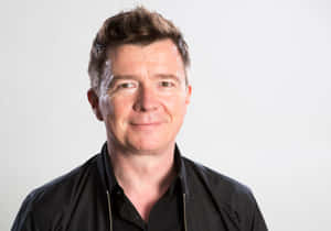 Rick Astley Rocking On Stage Wallpaper