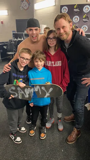 Rising Wrestling Star Sammy Guevara Posing For A Photo With Adoring Fans. Wallpaper