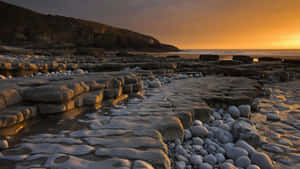 Rocks Coastal Sand Stones Sunset Wallpaper