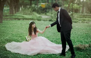 Romantic Asian Couple Prenup On Grass Wallpaper