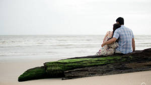 Romantic Couple Enjoying Sunset On Tropical Beach Wallpaper