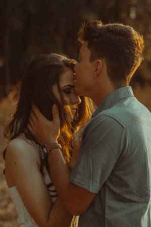 Romantic Couple Forehead Kiss Wallpaper