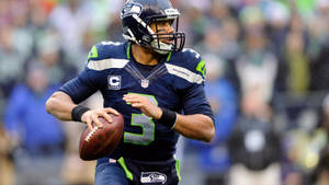 Russell Wilson Holding Football Wallpaper