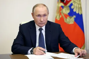 Russian President Vladimir Putin Seated At Meeting Table With Notes Wallpaper
