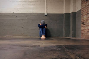 Sad Boi Against Cement Wall Wallpaper