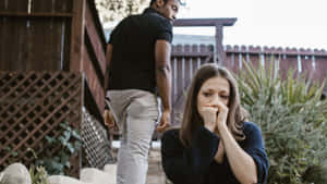 Sad Couple Sitting On The Stairs Wallpaper