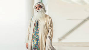 Sadhguru Standing On A White Hall Wallpaper