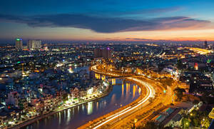 Saigon River And Night City View In Vietnam Wallpaper