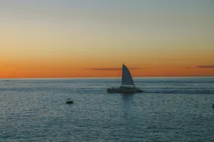 Sailing Catamaran On Calm Seas Wallpaper