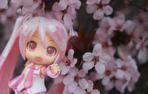 Sakura Miku Toy Beside Flowers Wallpaper