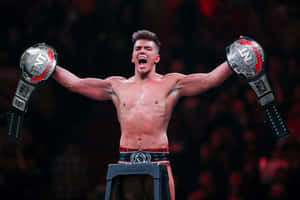 Sammy Guevara With His Championship Belts Wallpaper