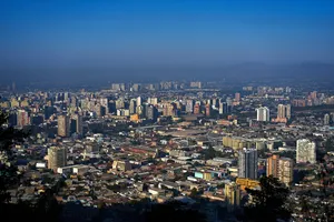 Santiago's Majestic Skyline Under A Blue Hazy Sky Wallpaper