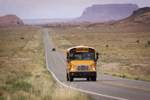 School Bus On Long Rural Road Wallpaper