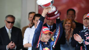 Sebastian Vettel Holding Up A Trophy Wallpaper