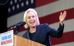 Senator Kirsten Gillibrand Extending Her Left Hand In A Gesture Of Engagement Wallpaper