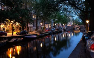 Serene Amsterdam Canal At Dusk Wallpaper