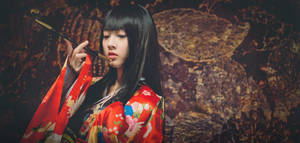 Serene Japanese Girl Enjoying A Pipe Wallpaper