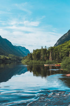 Serene Lake Amidst The Mountains Wallpaper