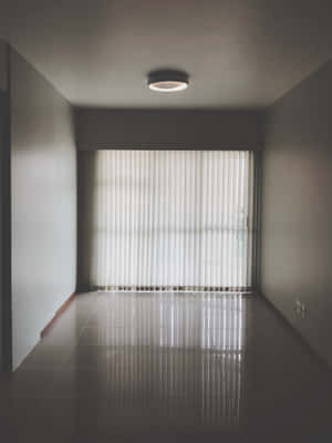 Serene Simplicity: An Empty Room With Closed Curtains Wallpaper