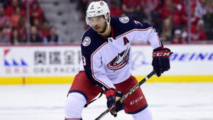 Seth Jones From Columbus Blue Jackets Pushing Hockey Stick Wallpaper