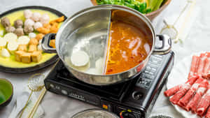 Shabu-shabu In Dual Pot On A Stove Wallpaper