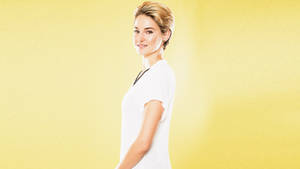 Shailene Woodley In Yellow Background Wallpaper