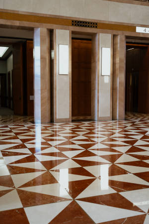 Shiny Elevator Corridor With Elegant Floor Tiles Wallpaper