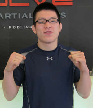 Shinya Aoki, A Dominating Force In Mixed Martial Arts, Posing In His 2011 Evolve Mma Gear. Wallpaper