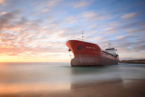 Ship Under Colorful Skies Wallpaper