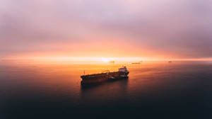 Ship Under Orange Skies Wallpaper