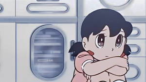 Shizuka Doraemon Hugging Knees Wallpaper