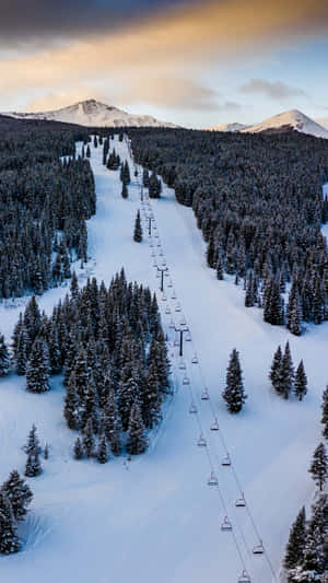 Shredding The Slopes At A Ski Mountain Wallpaper