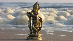 Shri Krishna Statue On Sand Wallpaper