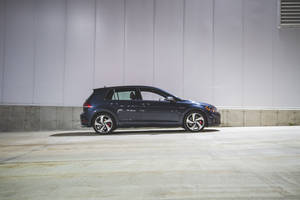 Side-view Of Blue Volkswagen Golf Gti Wallpaper