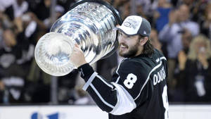 Side View Of Drew Doughty Happily Holding The Stanley Cup Wallpaper