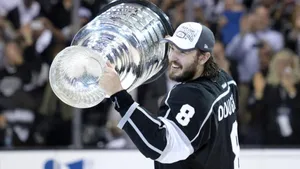 Side View Of Drew Doughty Happily Holding The Stanley Cup Wallpaper