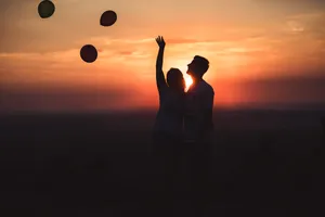 Silhouette Couple Releasing Balloons Wallpaper