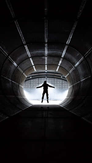 Silhouetted Figurein Tunnel Wallpaper