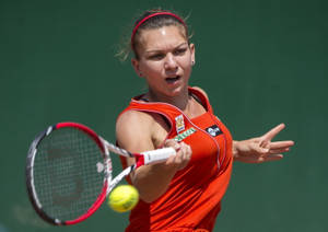 Simona Halep In Action Performing A Powerful Forehand. Wallpaper