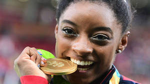 Simone Biles Gold Medal Bite Wallpaper