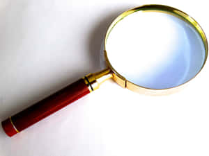 Single Magnifying Glass Golden Frame Wallpaper