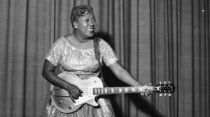 Sister Rosetta Tharpe Joyfully Playing Guitar Wallpaper