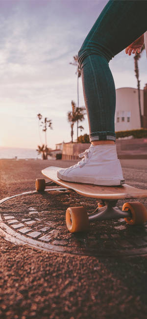 Skateboard Above A Manhole Cover Sports Iphone Wallpaper