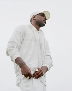 Skepta On Full White Outfit Wallpaper