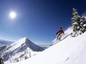 Skiing Over A Hill Wallpaper