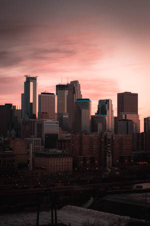 Skylines And Pink Clouds City Background Wallpaper